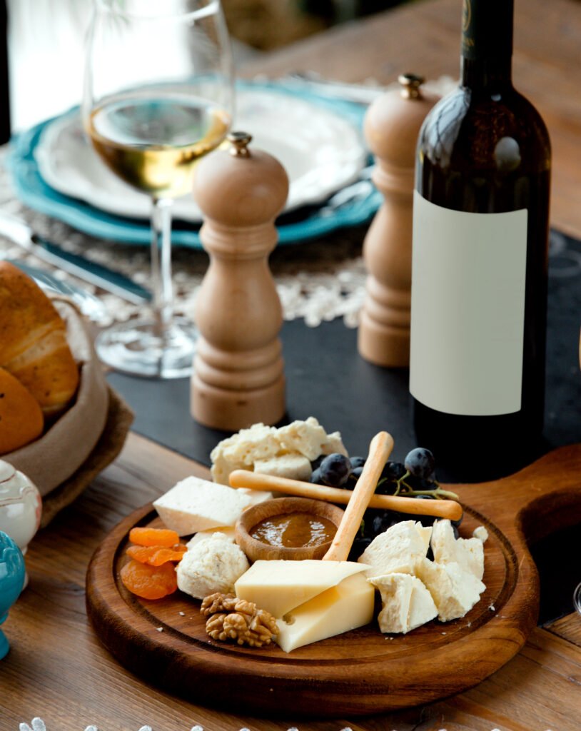 cheese set with red wine on wooden board