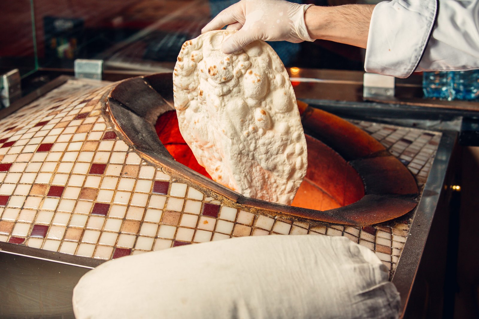 chef-cooking-lavash-bread-inside-oven-tandir