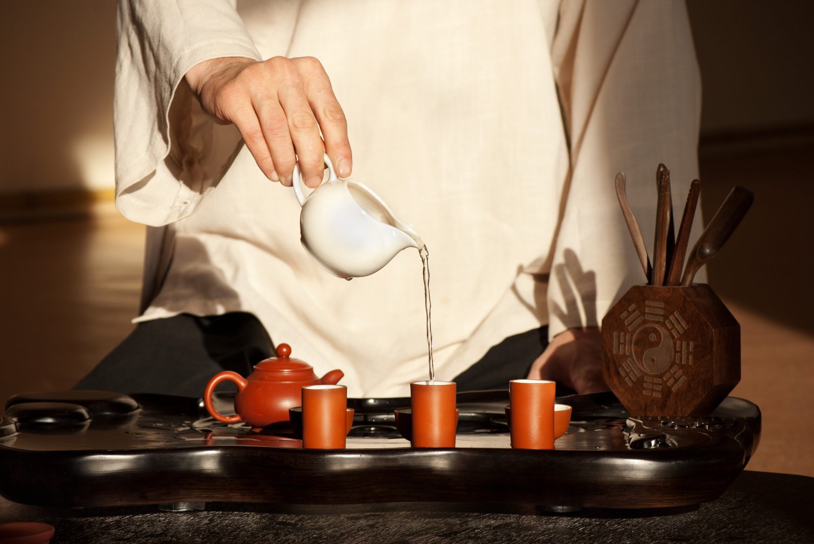Young man holds a Chinese tea ceremony