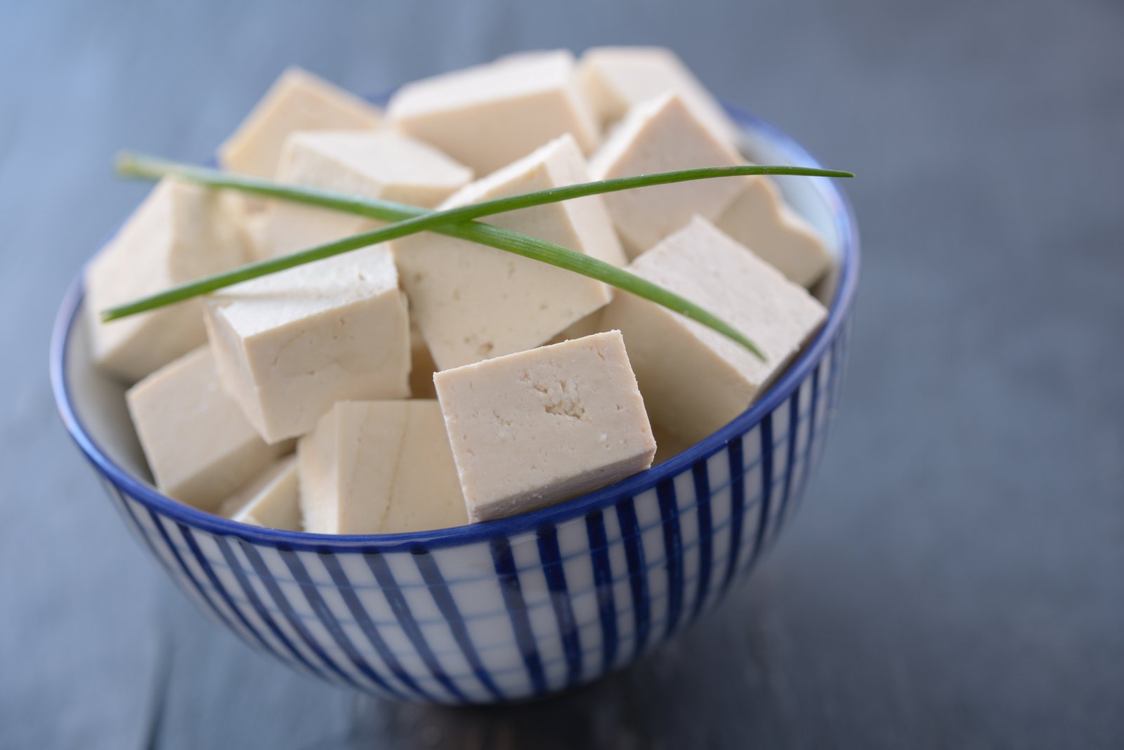cubes-of-tofu-in-a-bowl-with-green-onion-leafs-6178790690