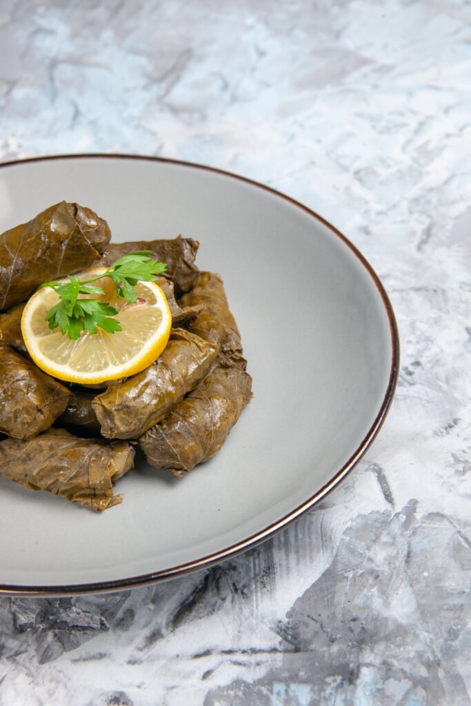 front-view-tasty-leaf-dolma-inside-plate-light-white-surface