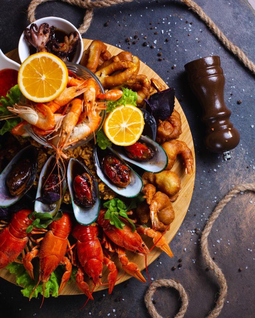 seafood plate with shrimps, mussels, lobsters served with lemon