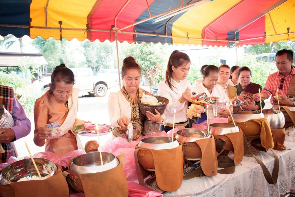 pexels-photo-10333232-10333232 Group participating in a traditional Buddhist offering ceremony at an outdoor gathering.