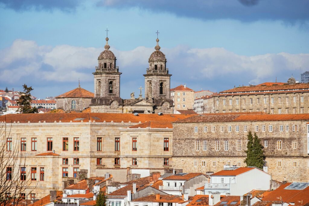 Panoramic view of Santiago de Compostela's historic architecture under a blue sky.
