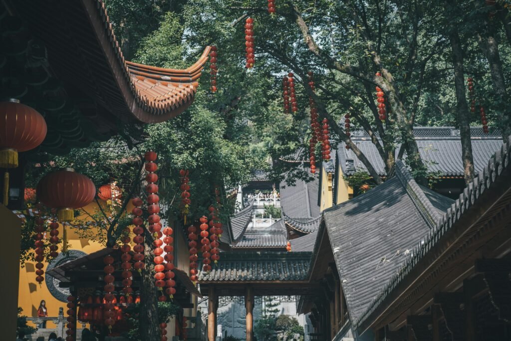 Traditional Chinese architecture with red lanterns at Faxi Temple in Hangzhou, China.