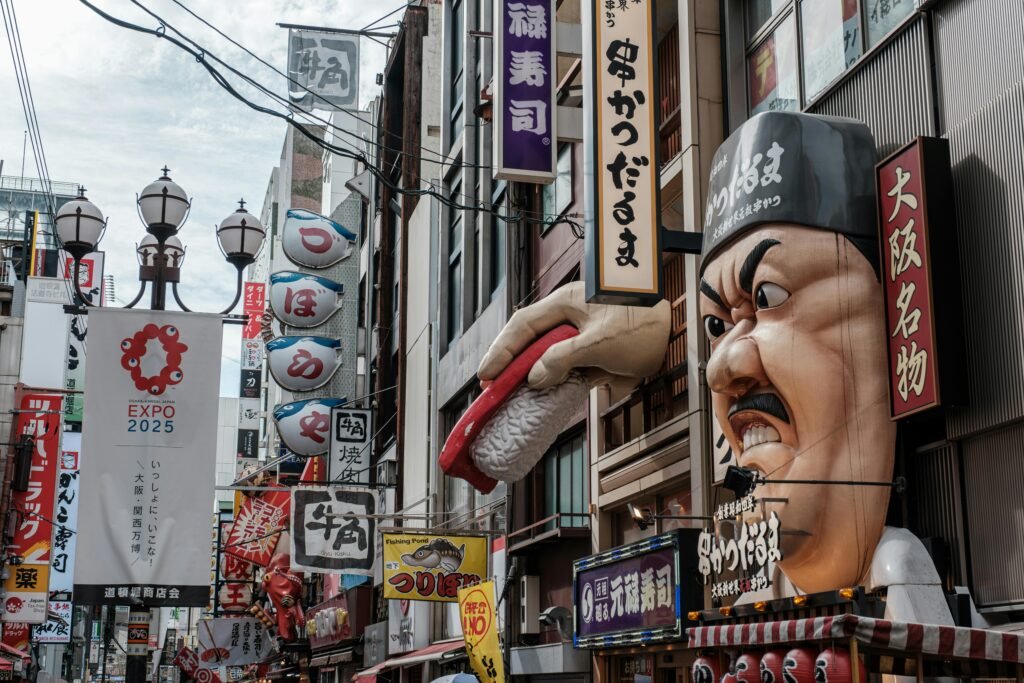 pexels-photo-18541509-18541509 Dynamic Dotonbori street view in Osaka highlighting bustling urban life with iconic signs and landmarks.