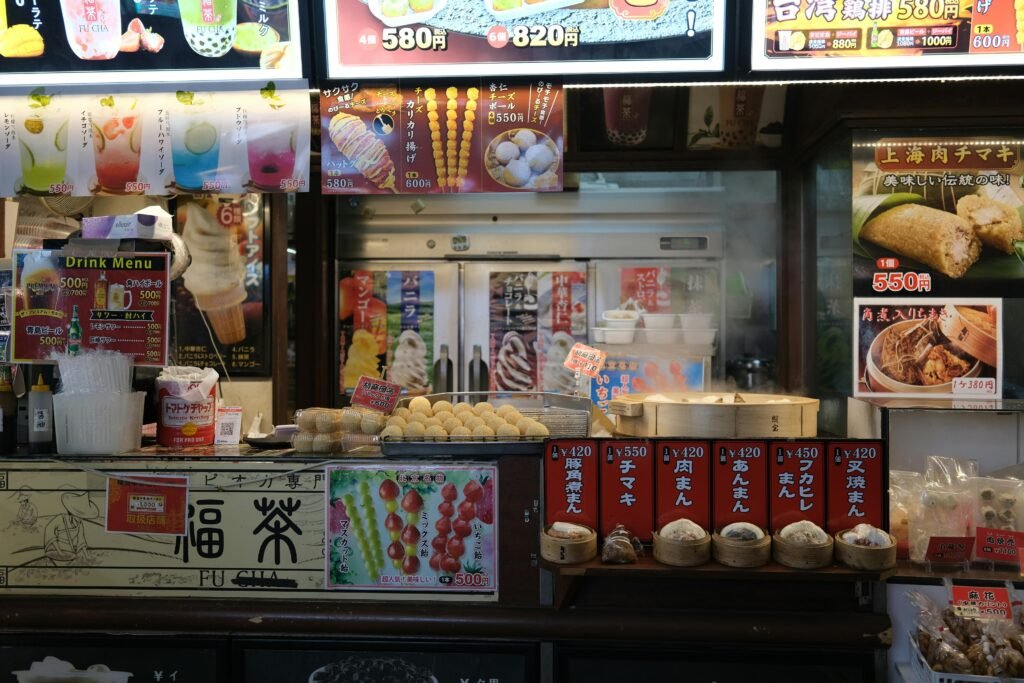 pexels-photo-23024254-23024254 Colorful Yokohama street food stall showcasing traditional snacks and drinks menus.