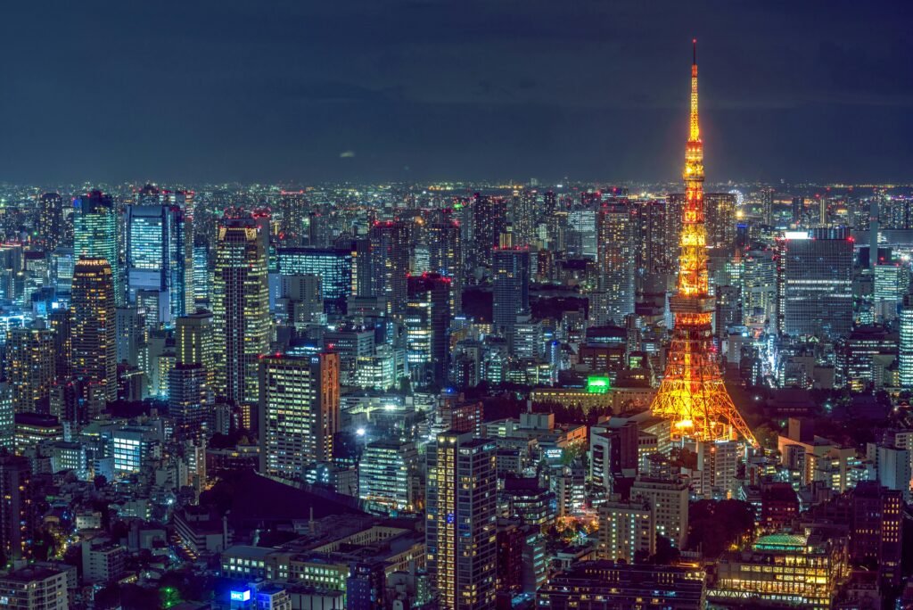 Tokyo culinary journey Stunning aerial view of Tokyo's vibrant cityscape with the illuminated Tokyo Tower at night.