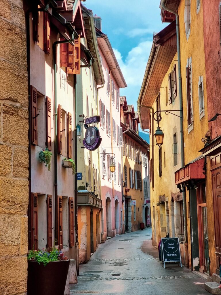 pexels-photo-27563640-27563640 Explore a picturesque alley in Annecy, France, featuring colorful buildings and gothic architecture.