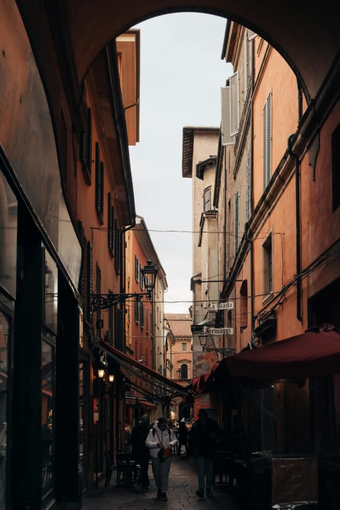 Explore the atmospheric streets of Bologna with this captivating alley scene.