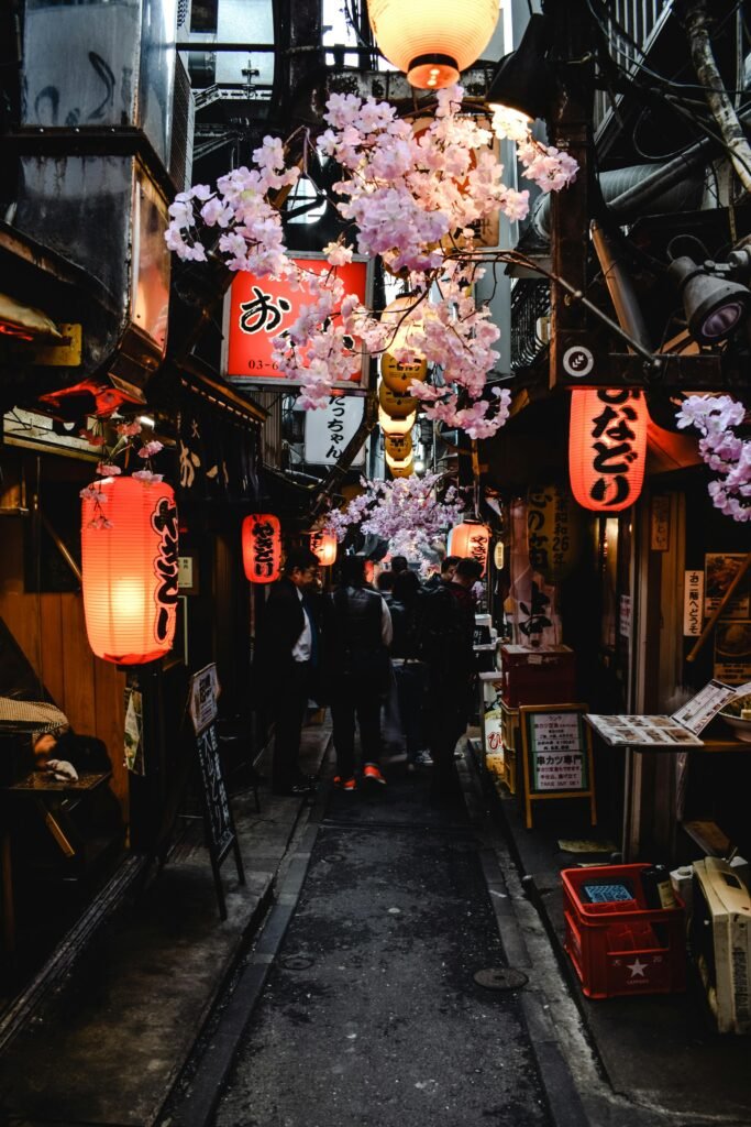 pexels-photo-5761962-5761962 Explore a lively Japanese alley adorned with lanterns and cherry blossoms in an atmospheric street market.