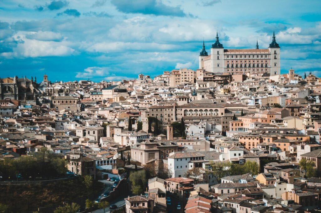 A breathtaking panoramic view of Toledo cityscape featuring the historic Alcazar under a vibrant sky.