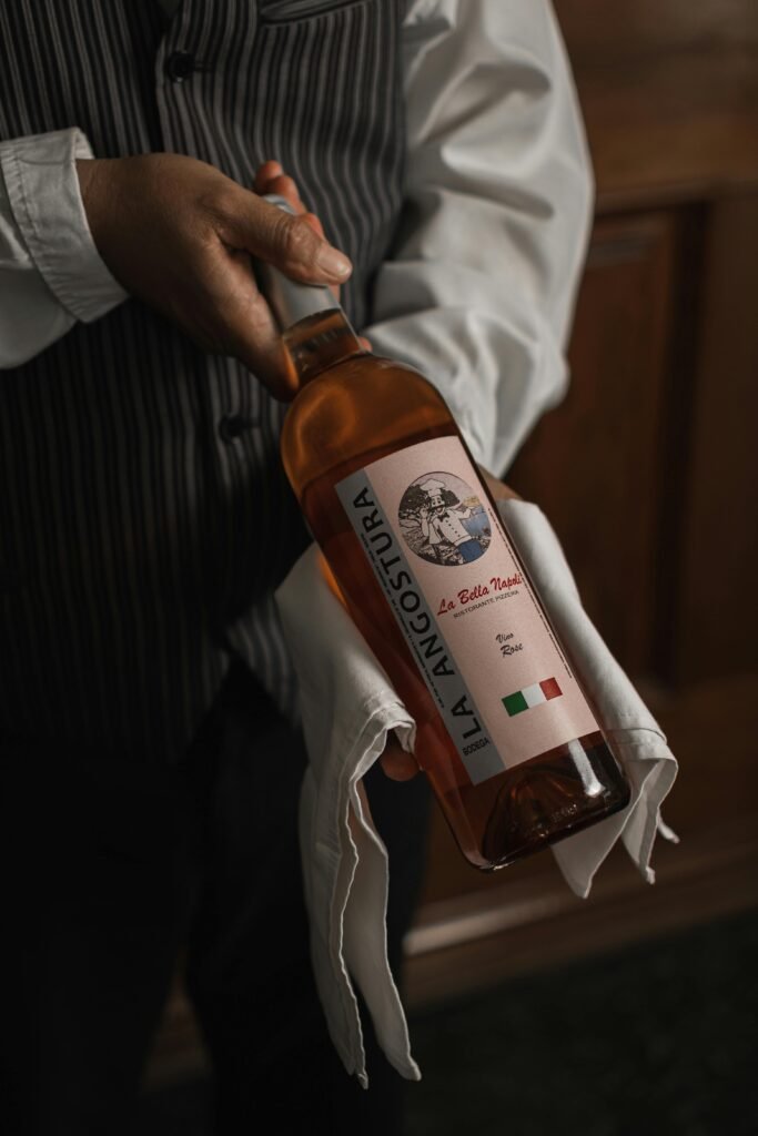 pexels-photo-15270300-15270300 Person presenting a bottle of Italian wine indoors, evoking sophistication.